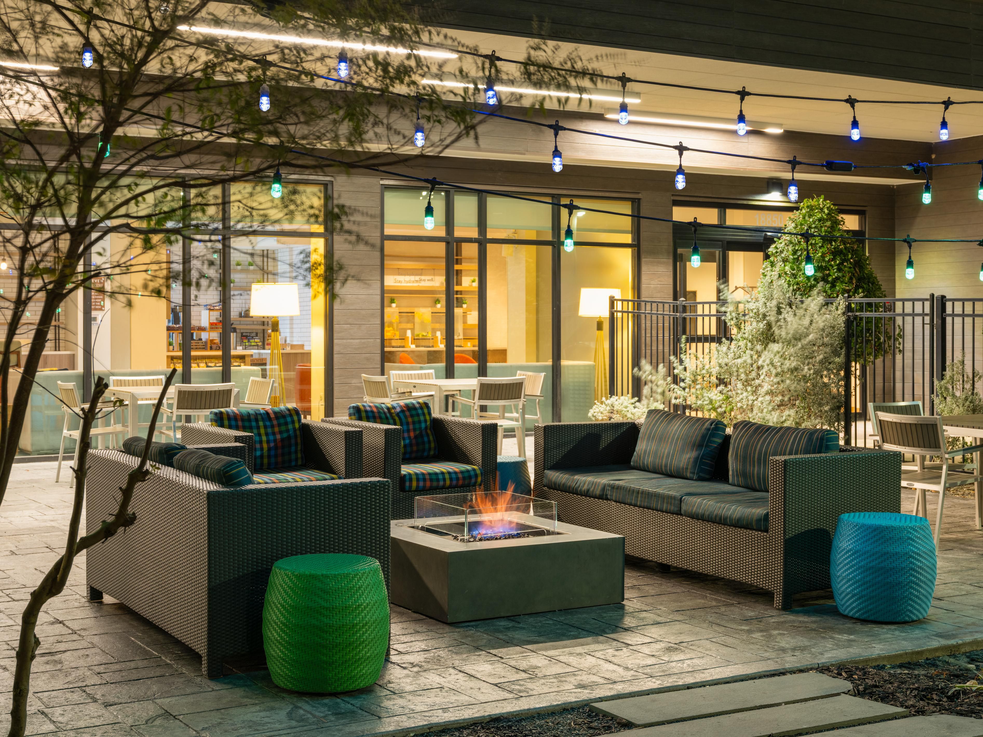 Outdoor patio area with seating and a firepit.