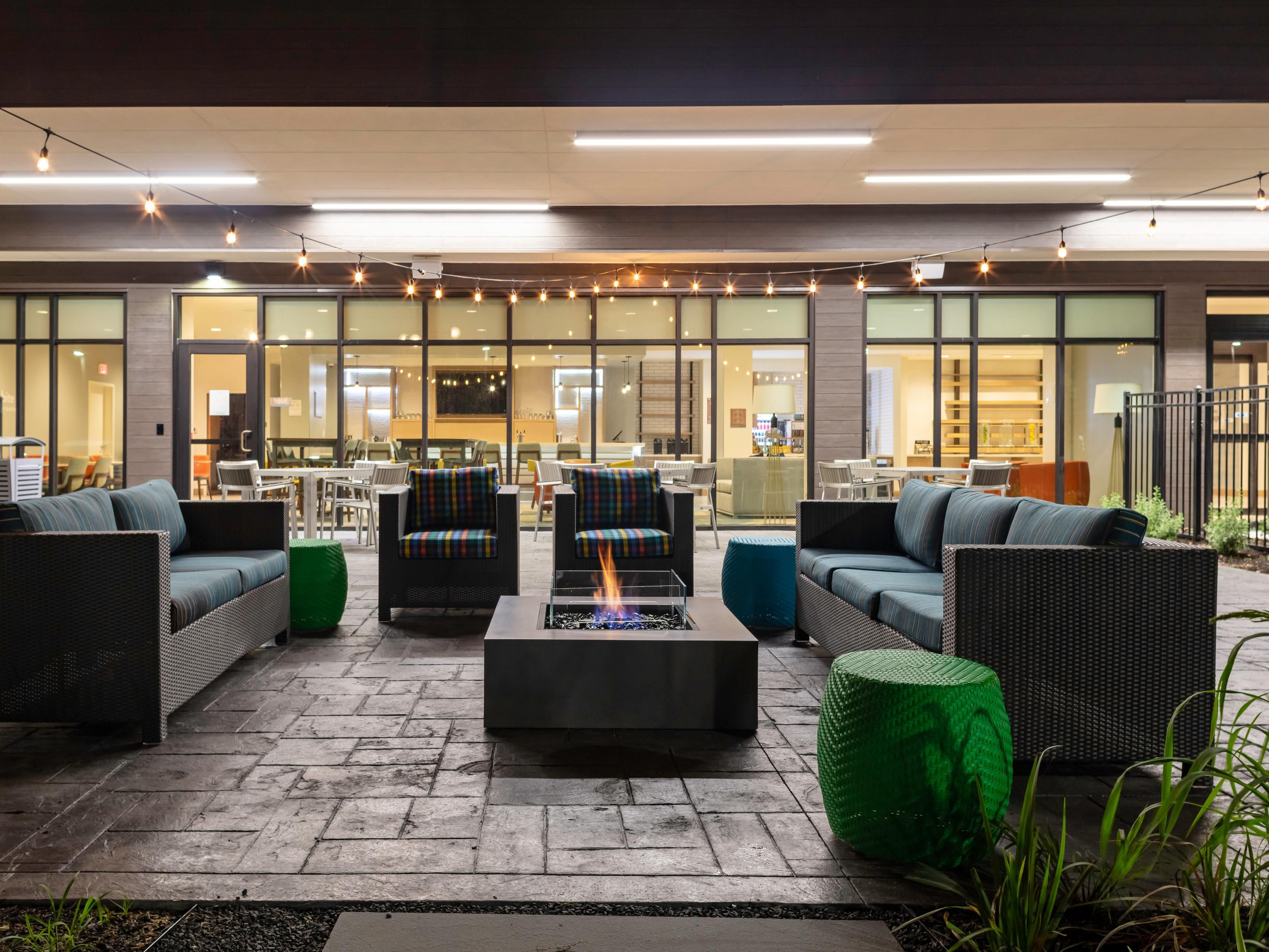 Outdoor patio area with seating and a firepit.