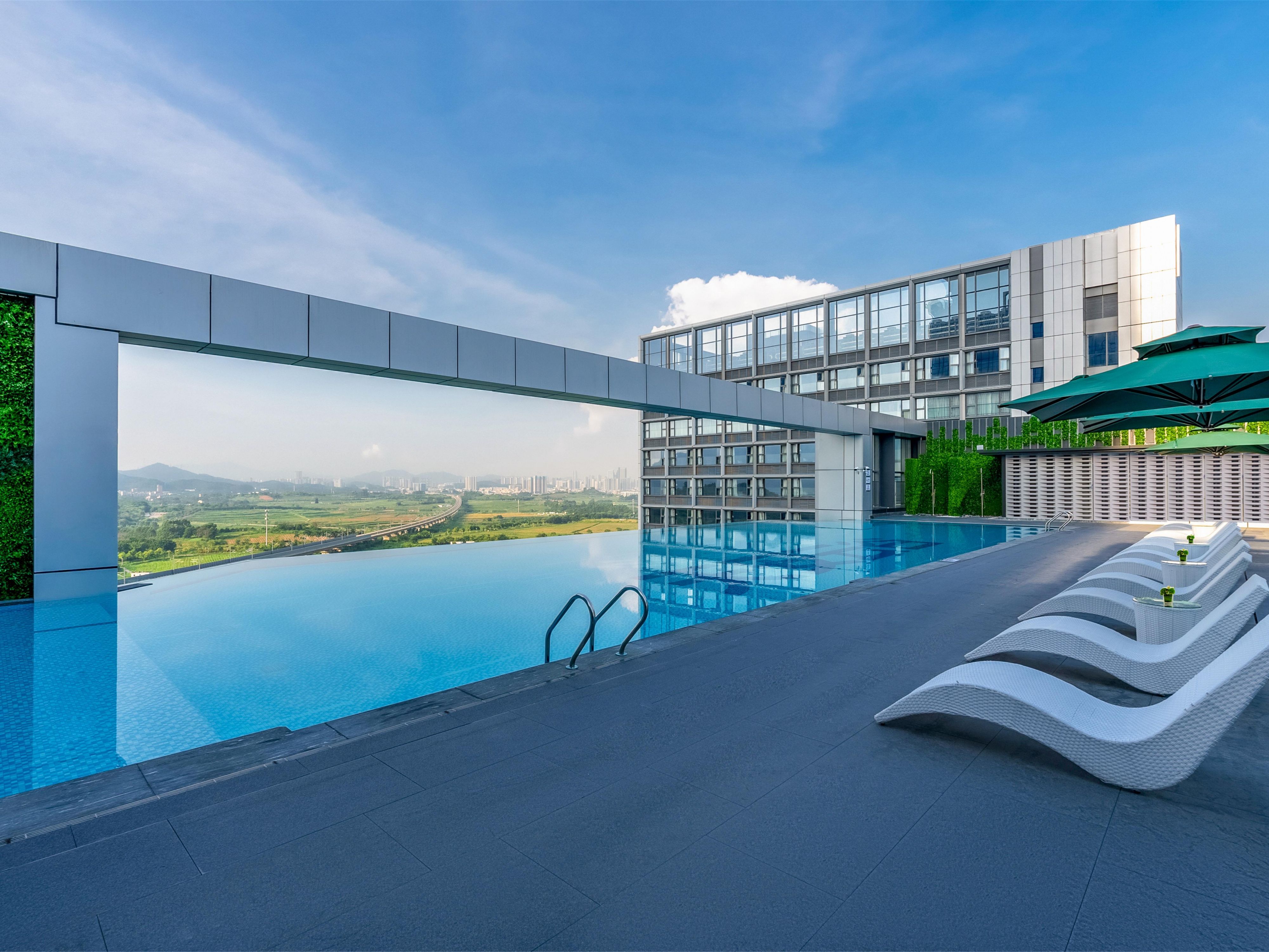 The infinity pool atop the hotel is a dreamy spot. Merges with the sky. Sparkling water in sunlight, with urban view. Swimming, feeling the breeze. City and skyline. Dusk brings a romantic glow. It's not just for swim, but a place of beauty and peace, making one reluctant to leave.