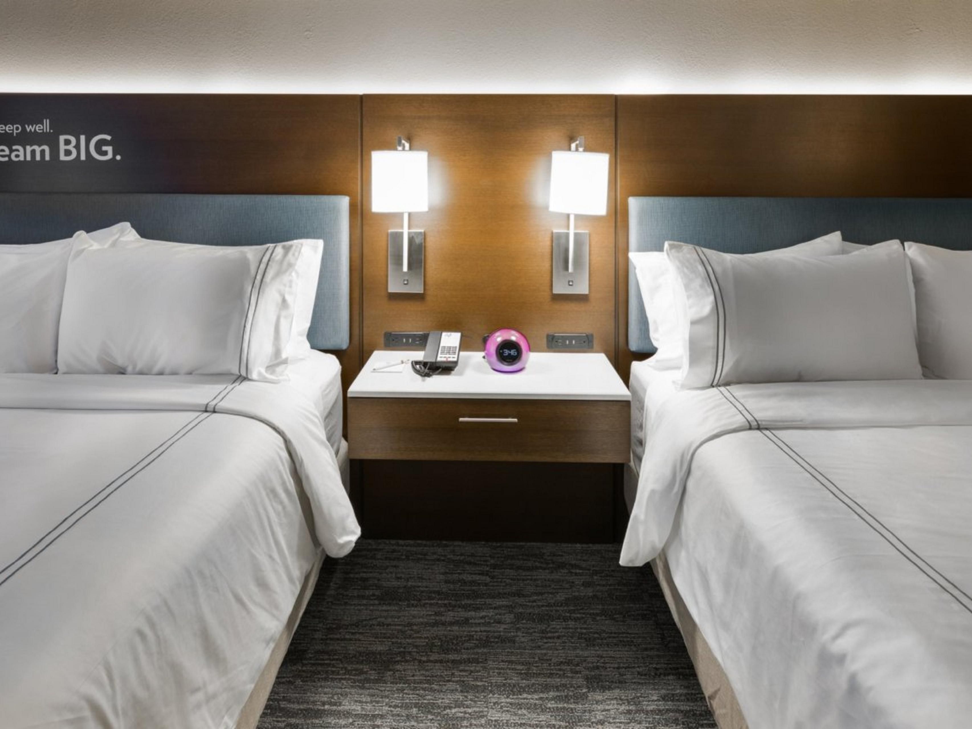 Double beds divided by a nightstand