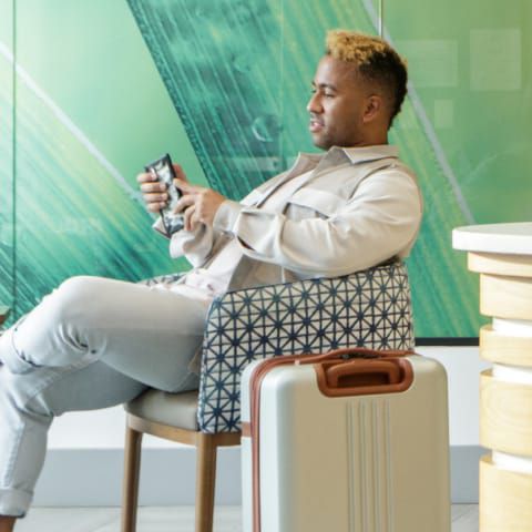 Man sitting down on a hotel lobby chair