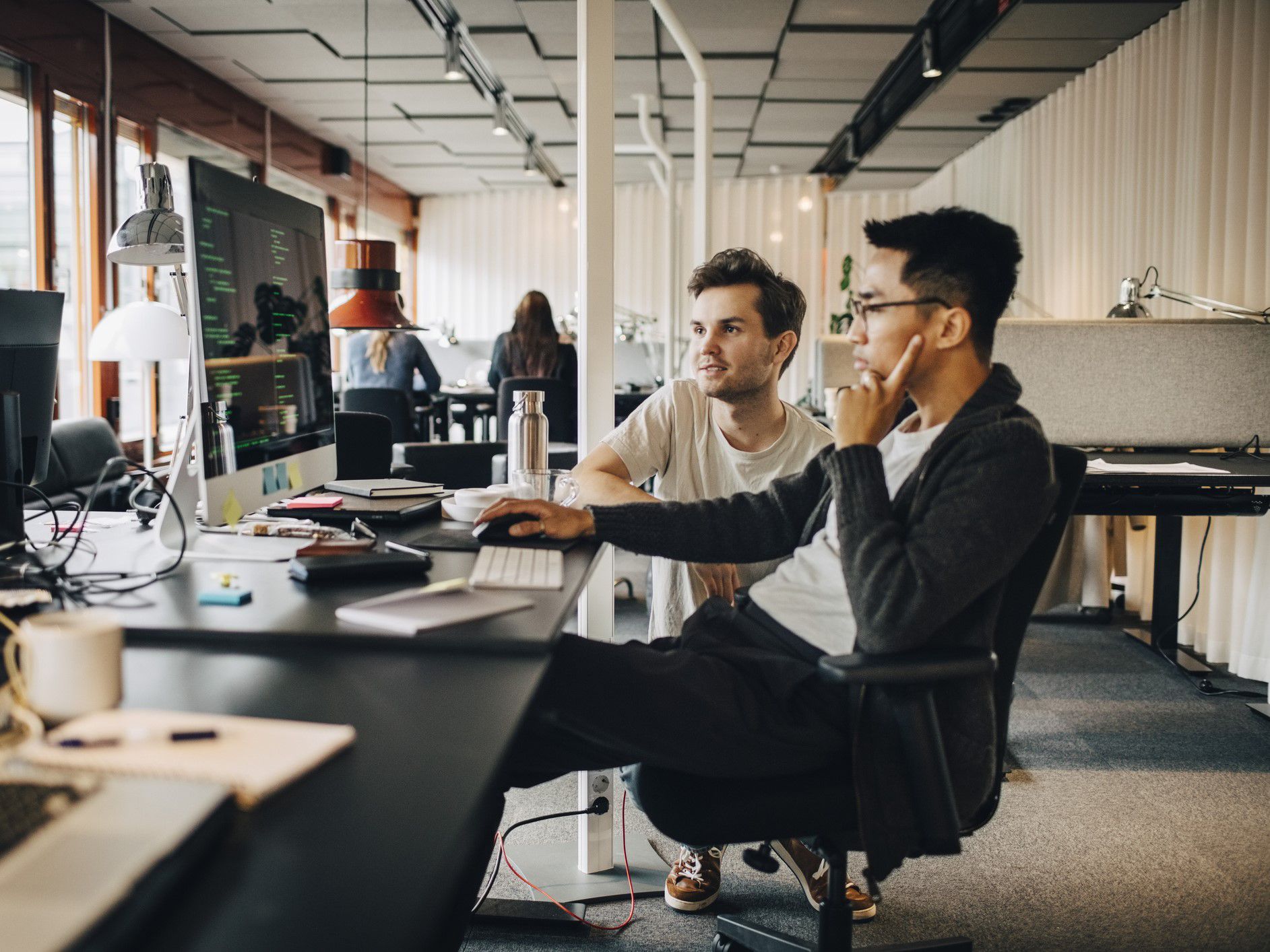 Tech employees working on a desktop