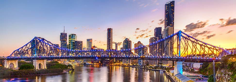 view of story bridge at dusk with Brisbane skyline in the background
