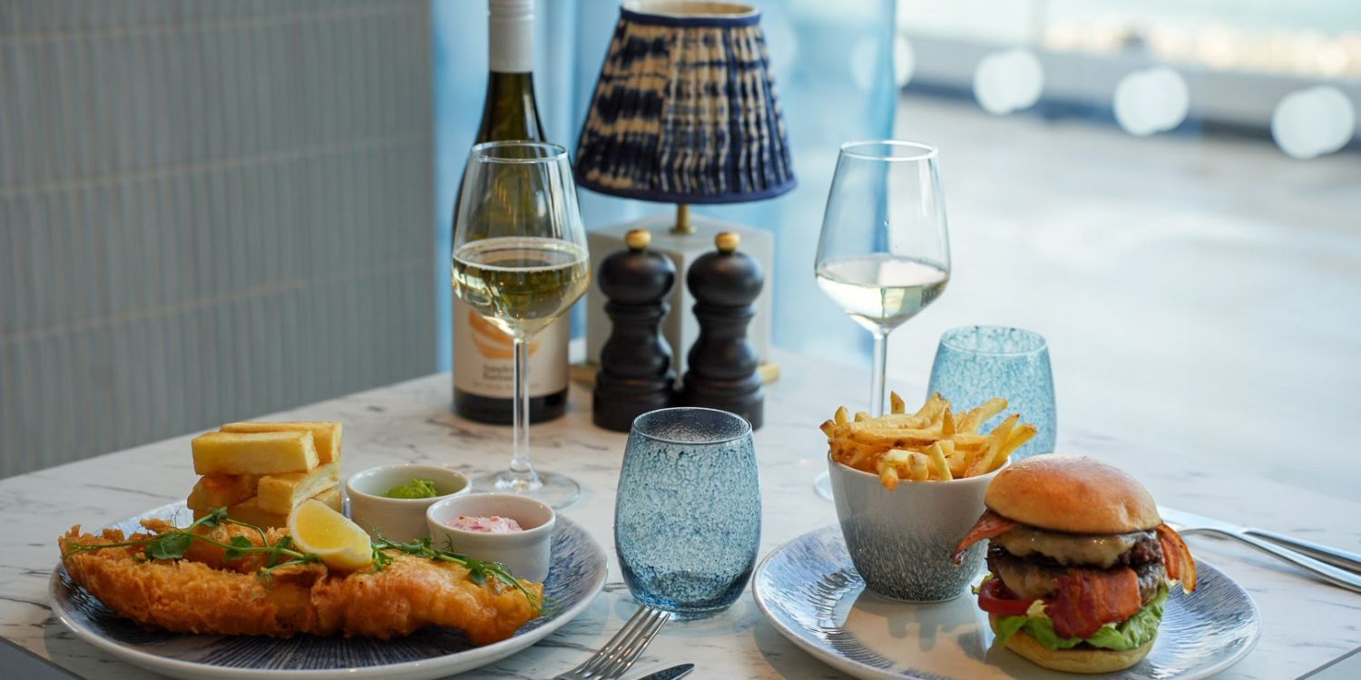 fish and chips, a burger and glasses of white wine