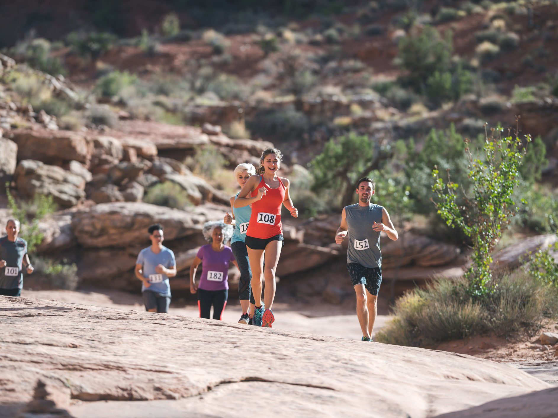 Family running a marathon in desert