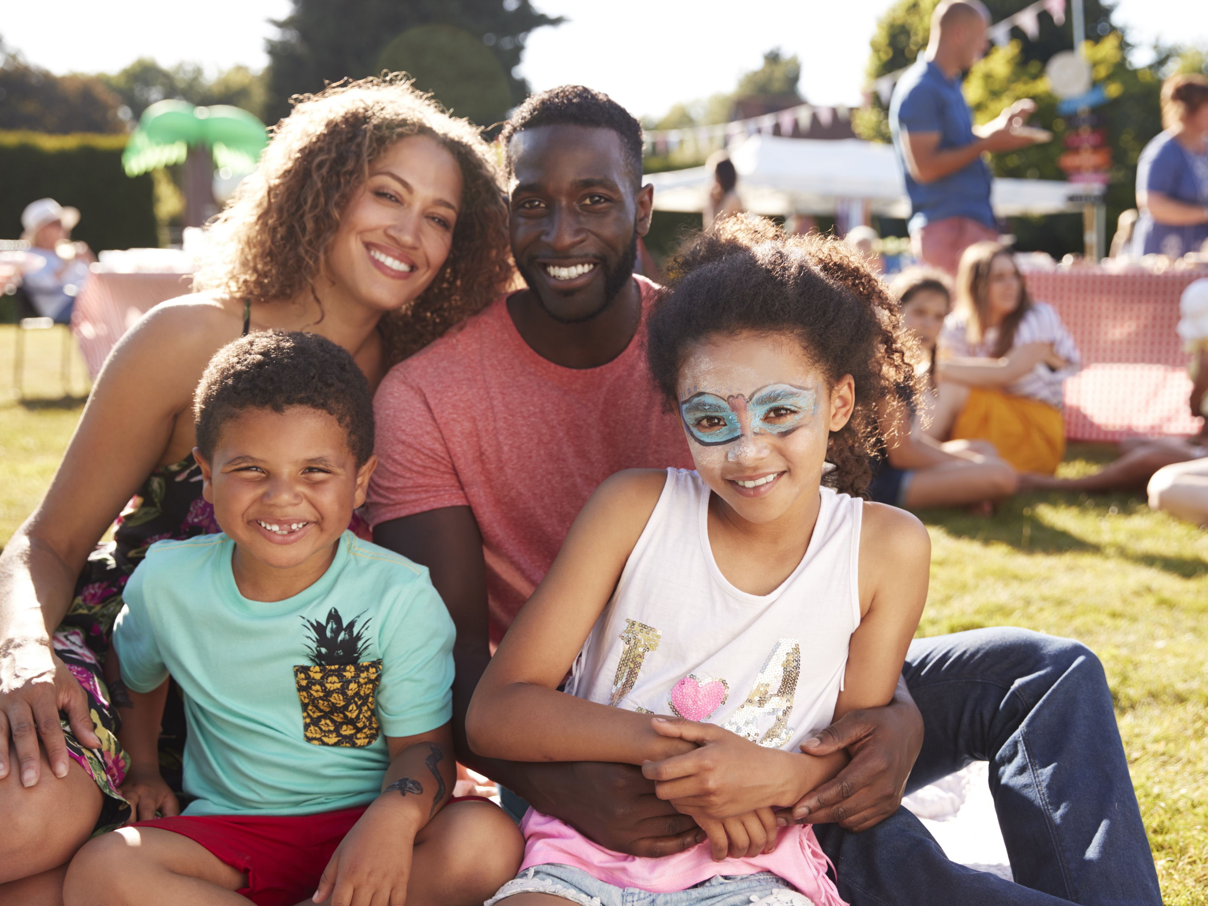 Family of four posing for a picture at a fair