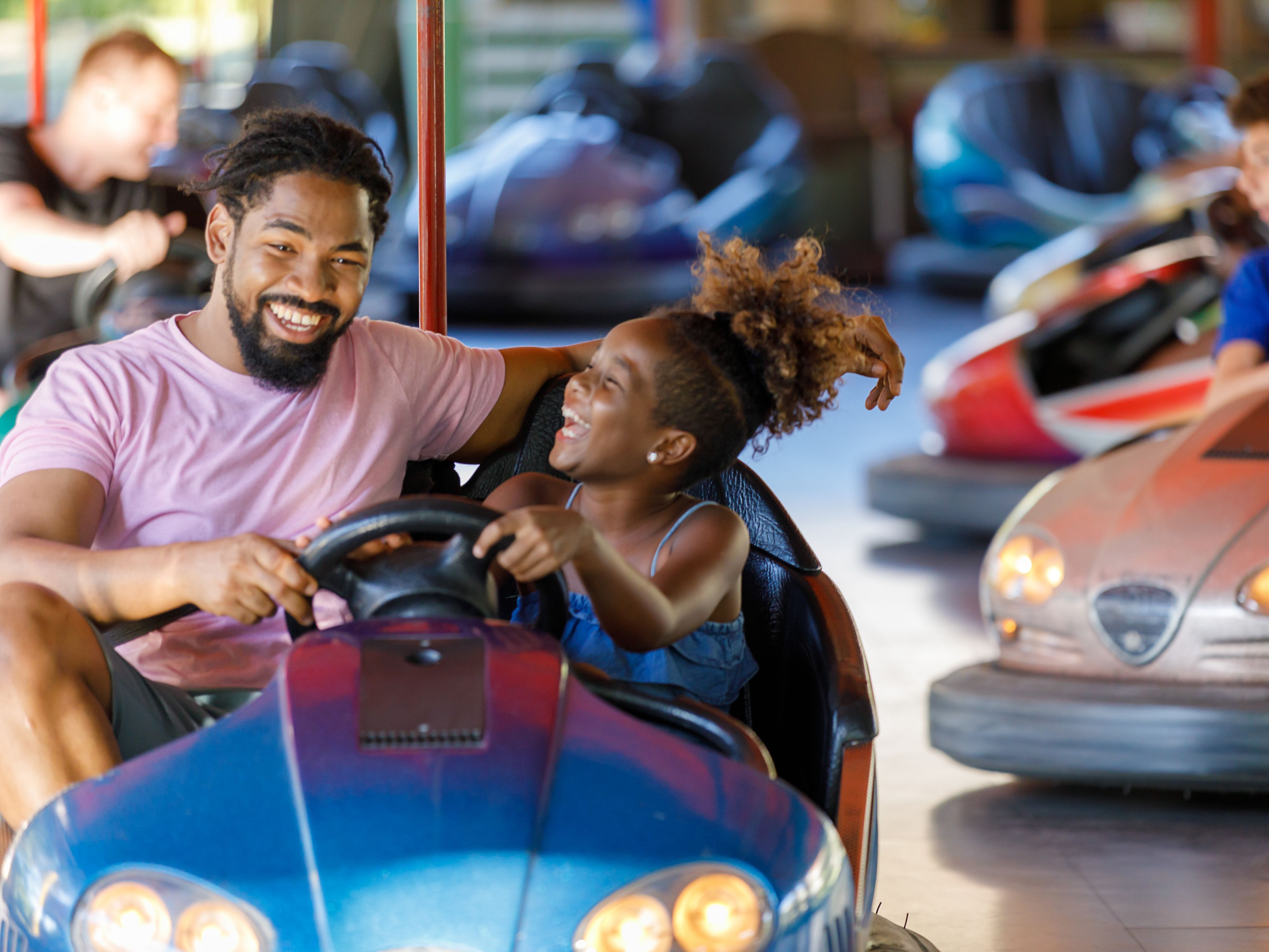 Father and daughter in bumper car