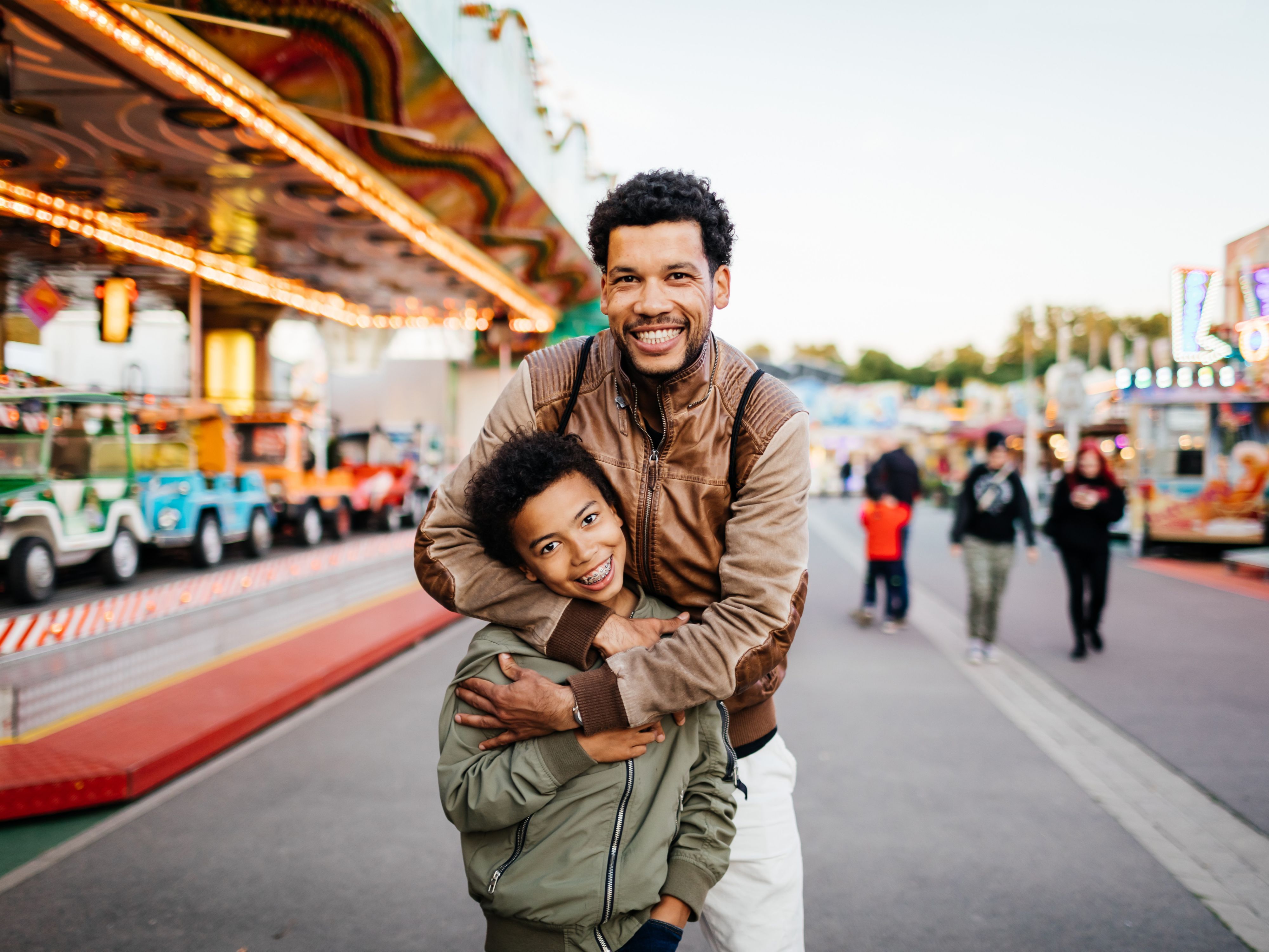 Father and son posing for a picture at a theme park