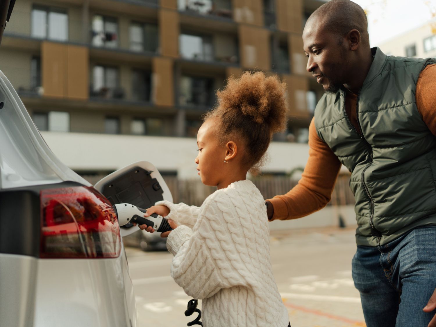 father and daughter charging car