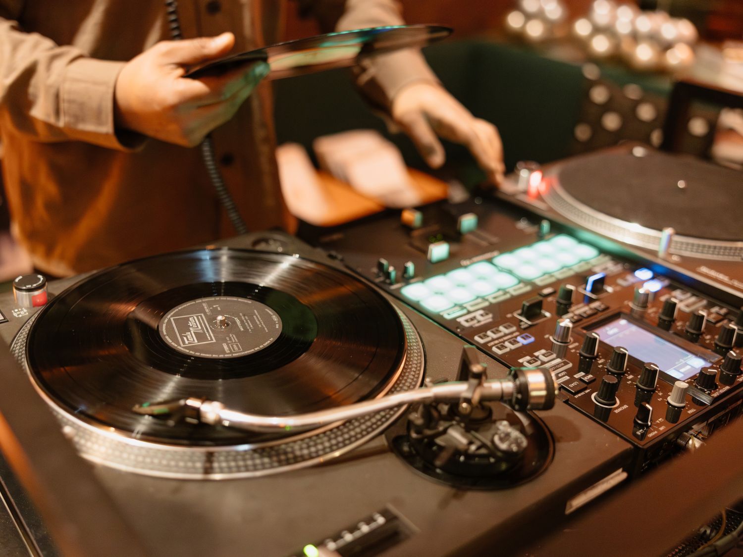 close up of dj playing on a deck
