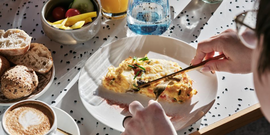 person eating a full breakfast