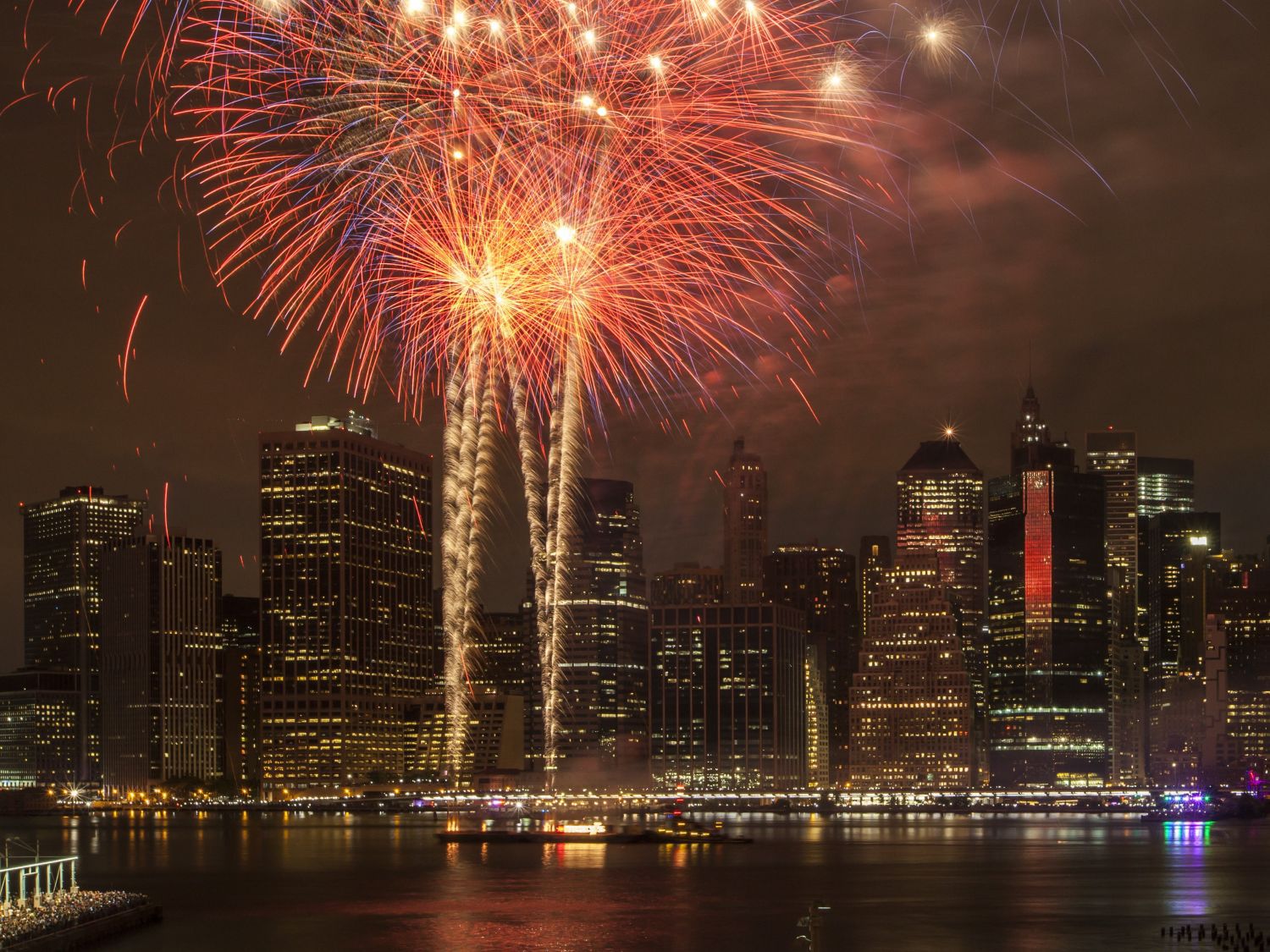 fireworks in the sky above the riverside 