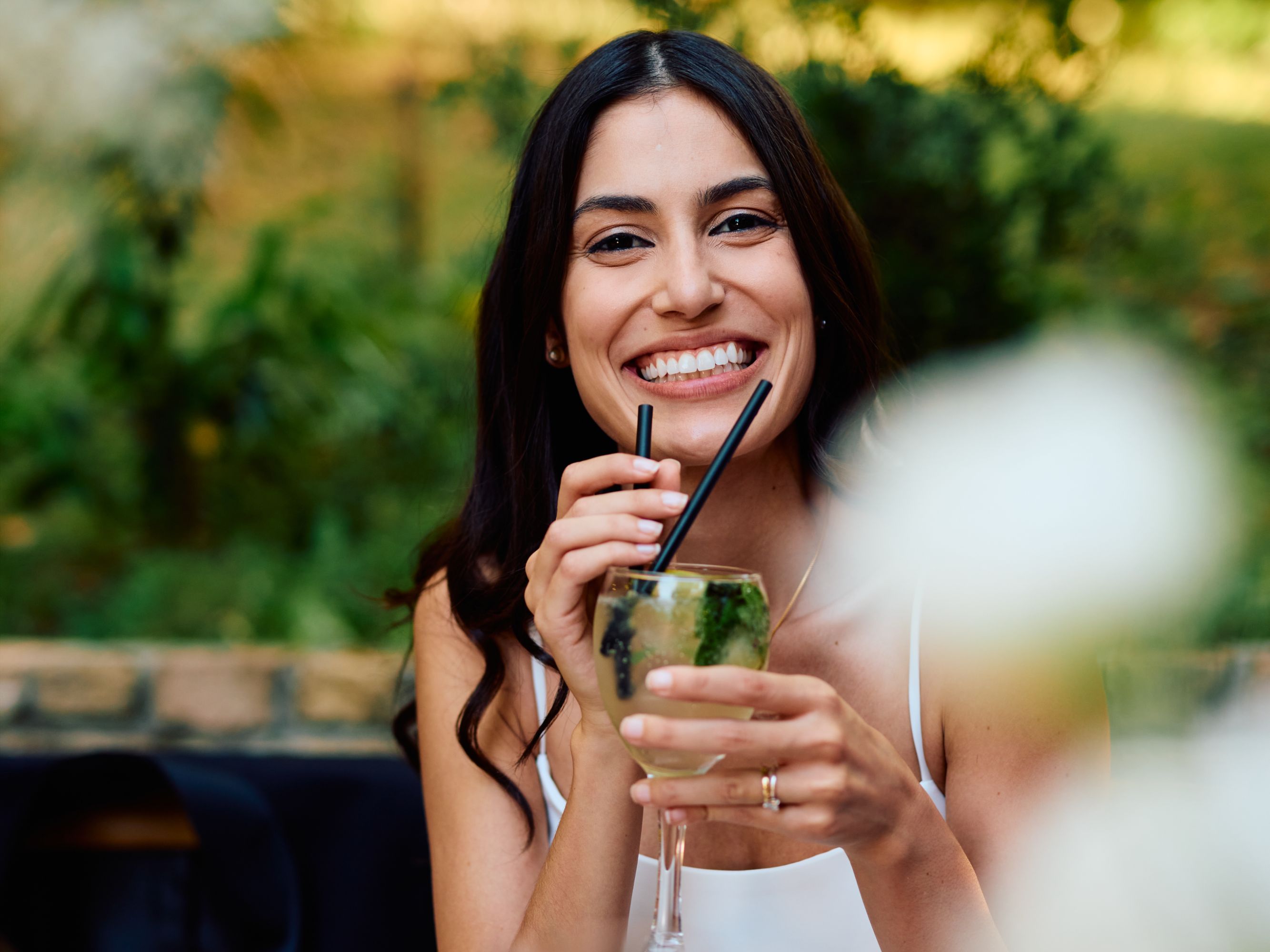 Woman enjoying a cocktail in the garden