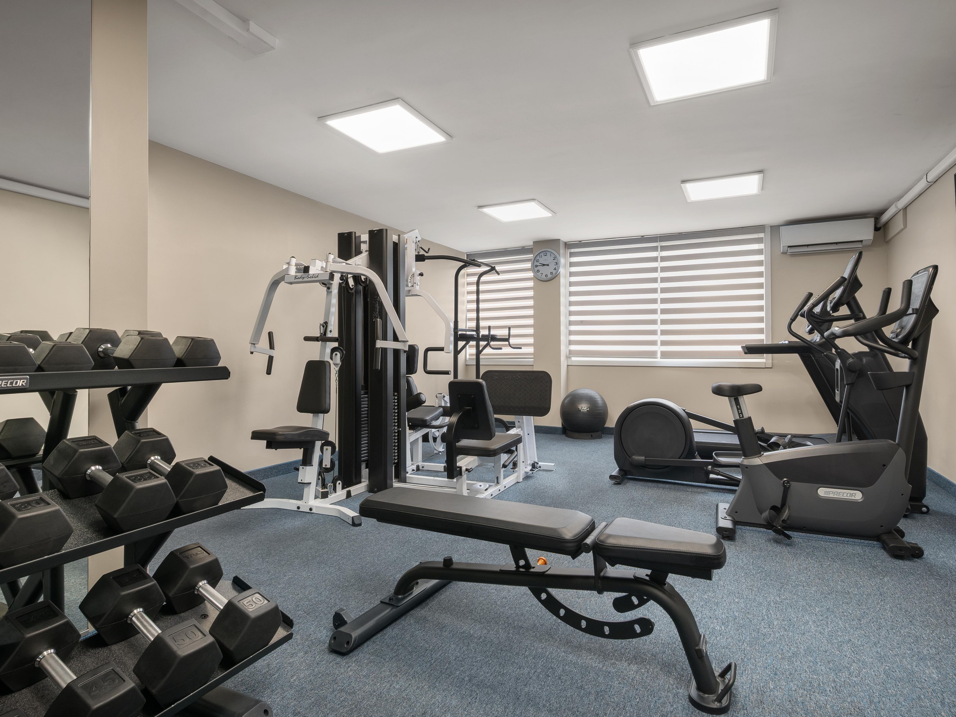 Guest fitness center with weights and machines.
