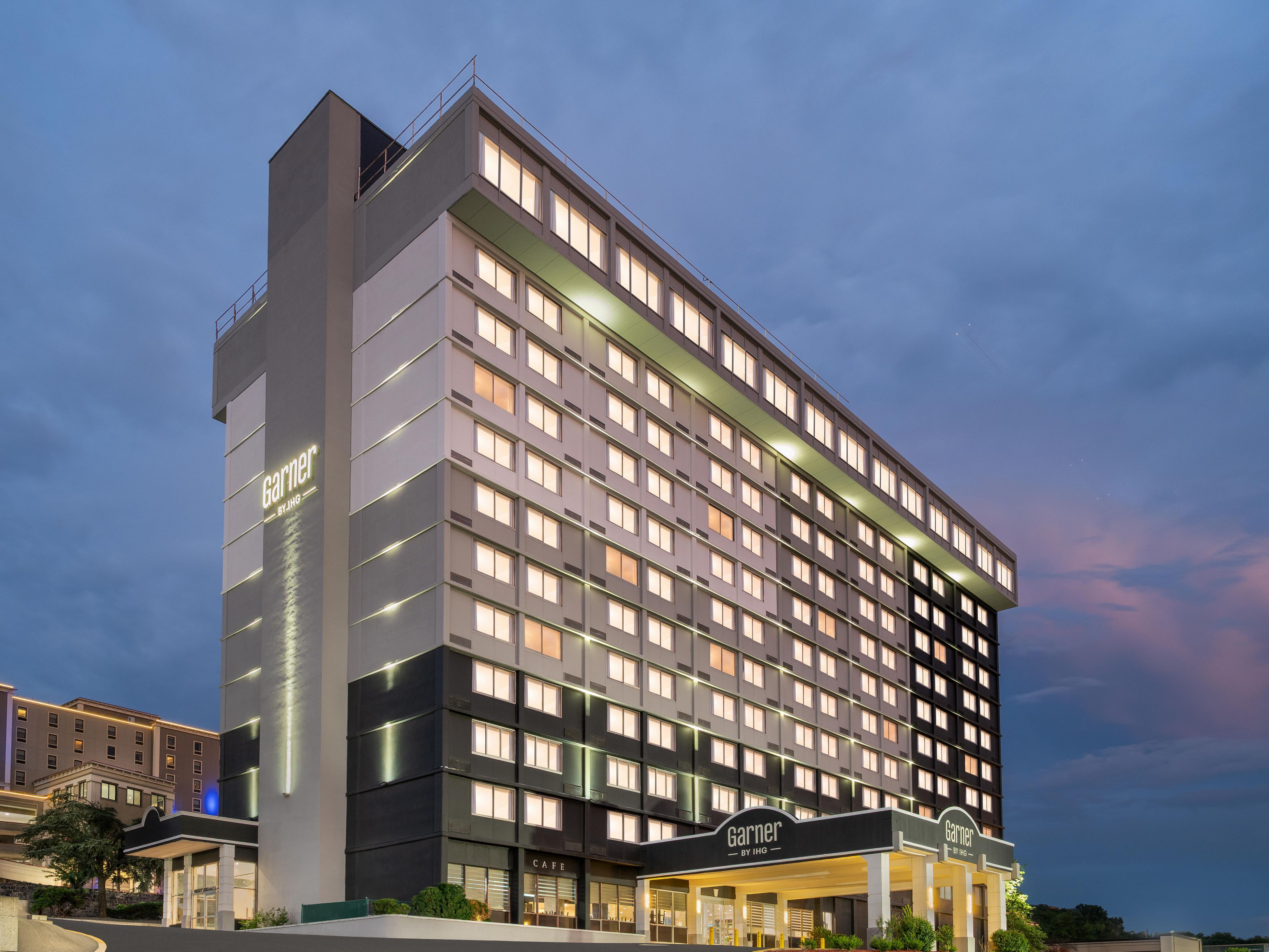 Exterior view of hotel at dusk.