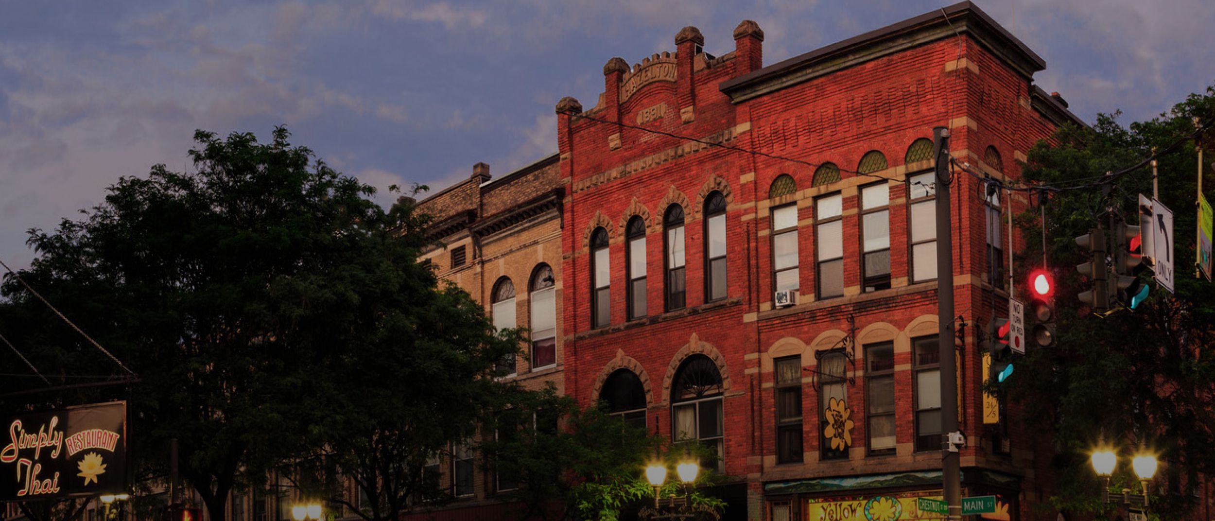 Street view image of city at dusk