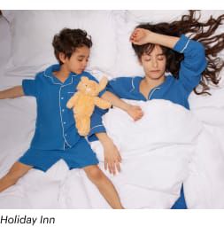 A mother and son sleeping comfortably in their Holiday Inn room