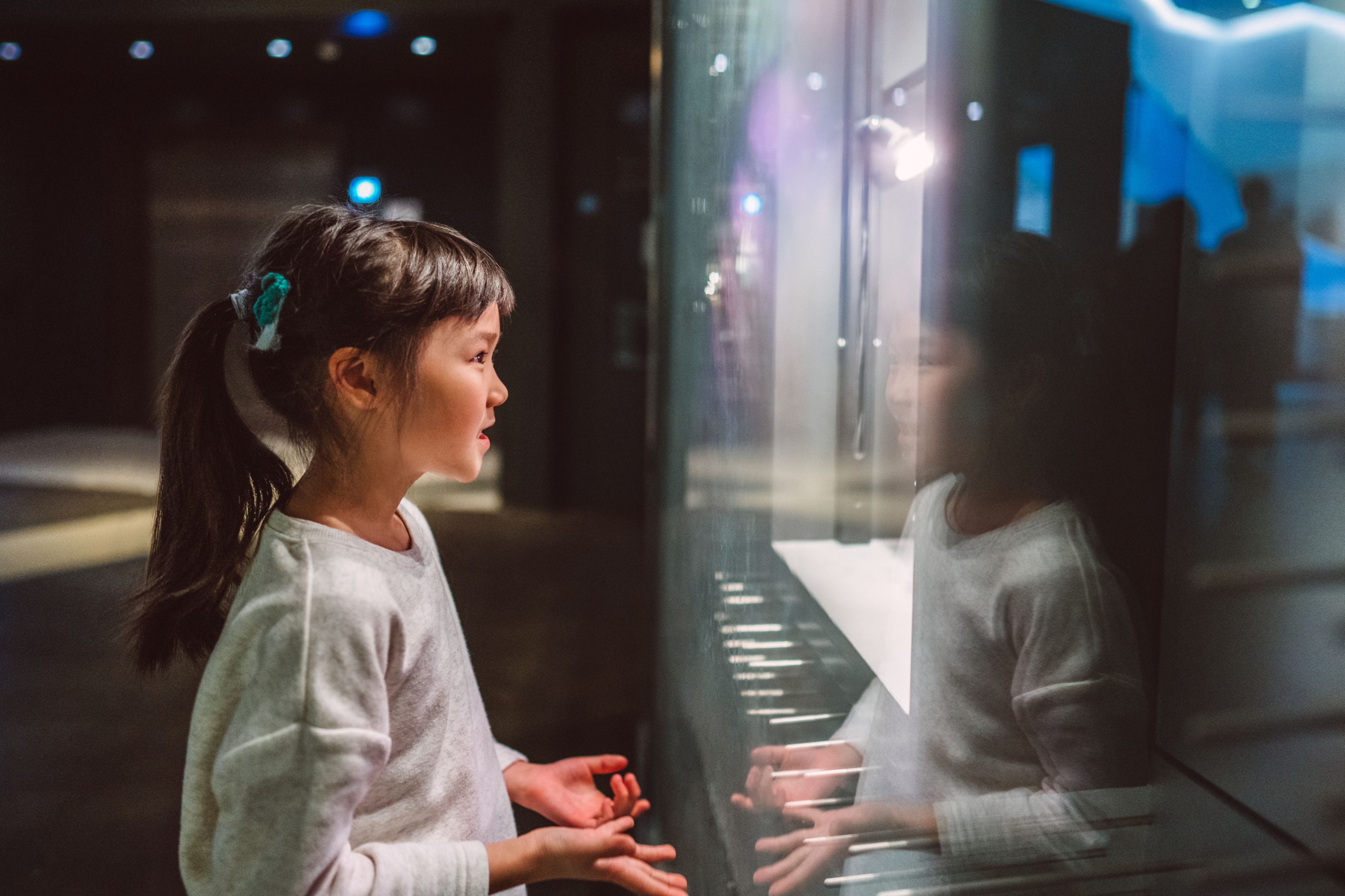 Girl looking at a museum exhibit.