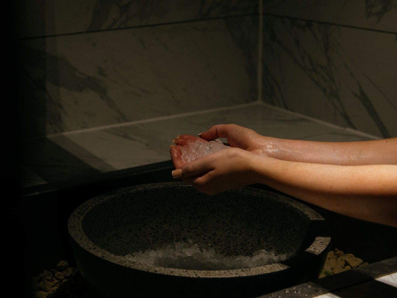 someone holding ice in their hands