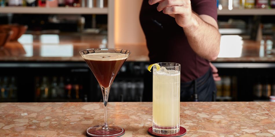 bartender adding finishing touches to cocktails