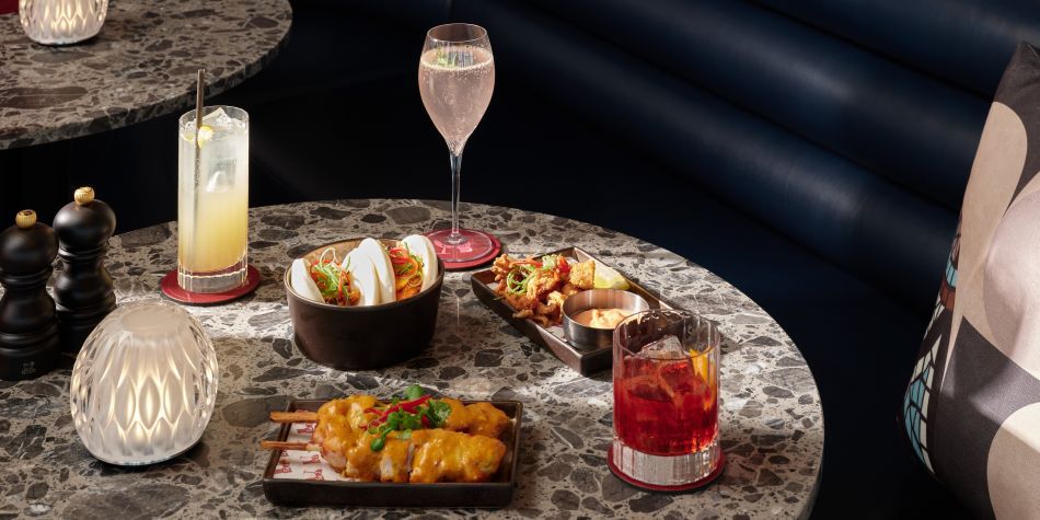 table with cocktails and a selection of small hot plates