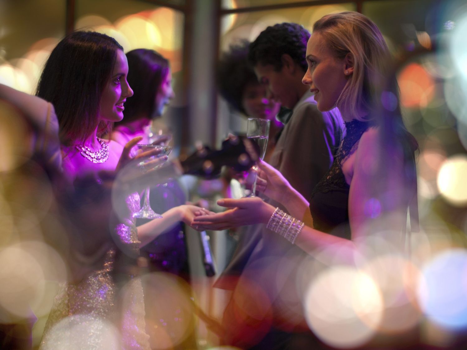 bartender pouring cocktail into glass