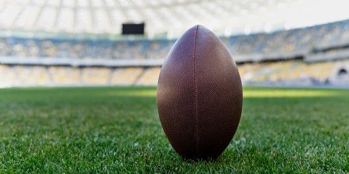 rugby ball on green grass at stadium