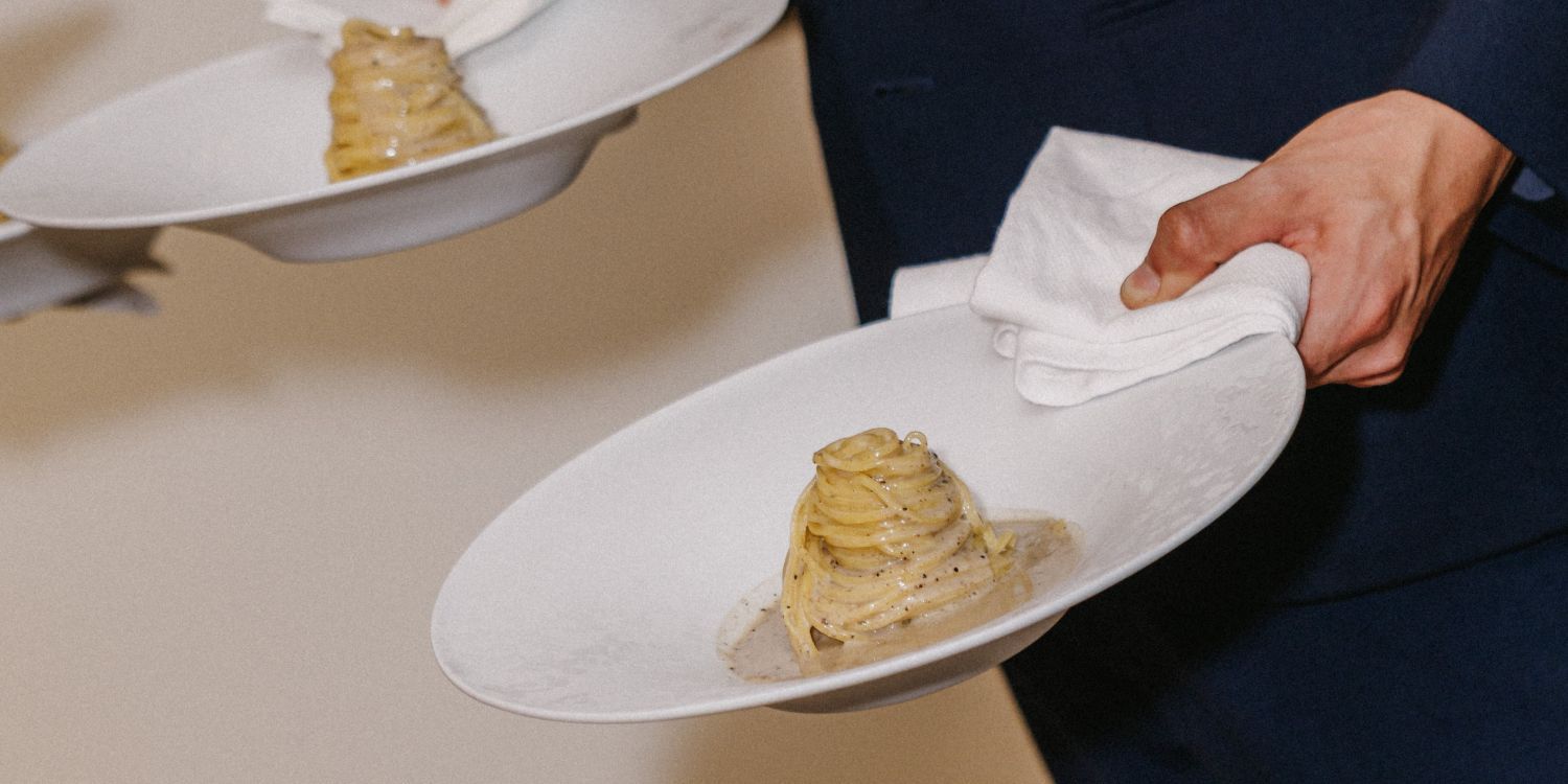truffle pasta being served by waiter