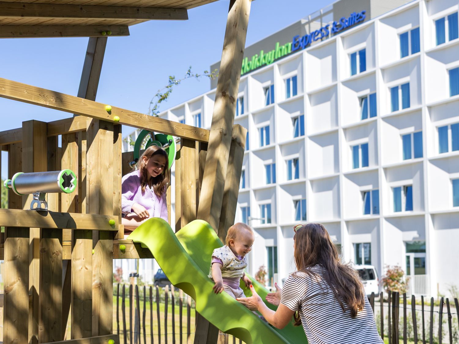 family playing in park outside hotel
