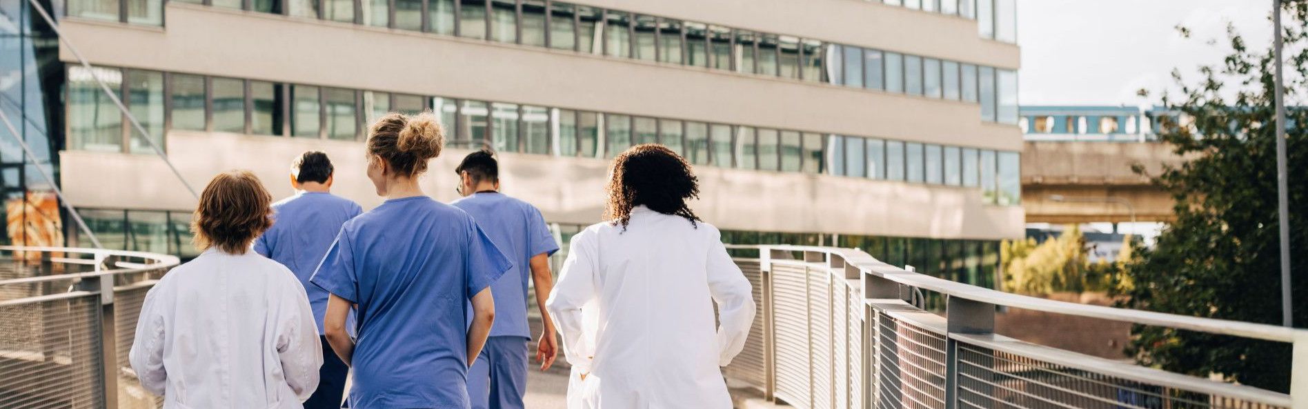 doctors walking towards hospital building