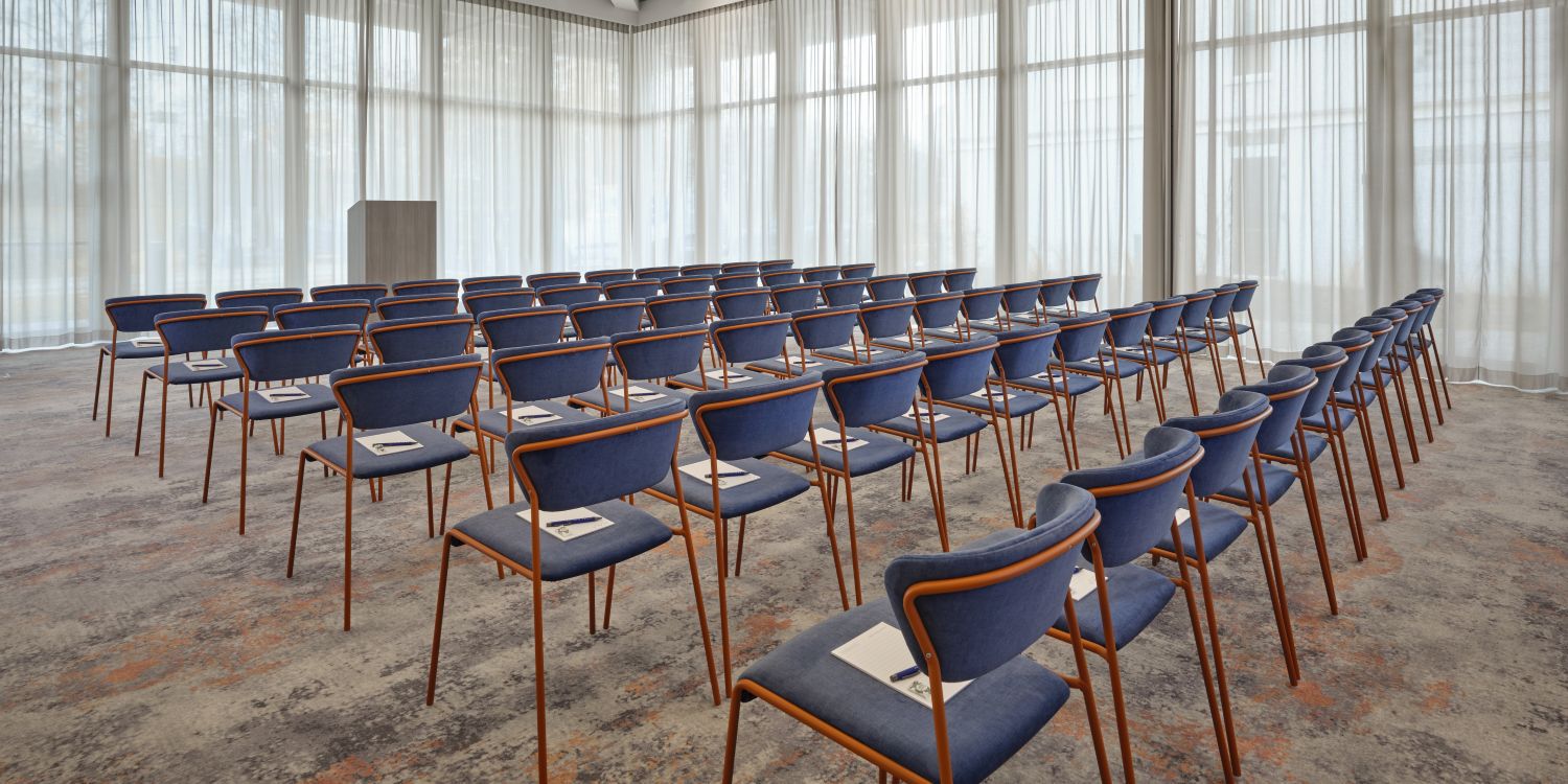 brightly lit meeting room with podium