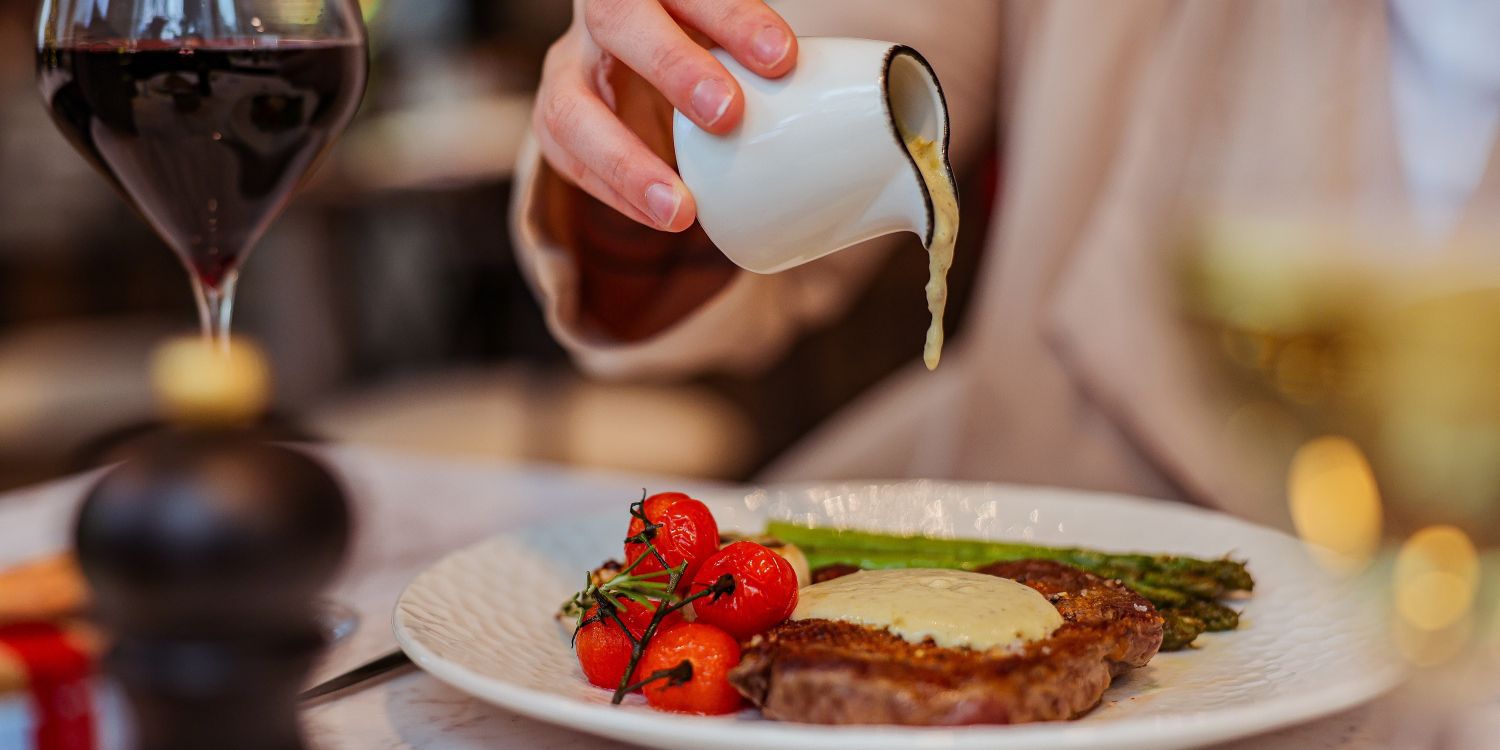 pouring sauce on steak