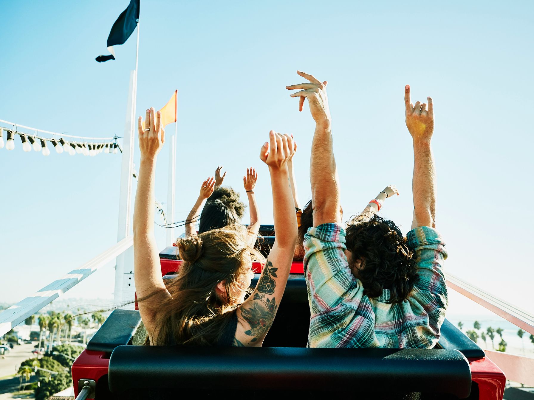 Guests riding in a roller coaster