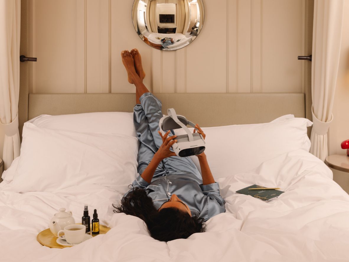 Guest on bed with VR headset