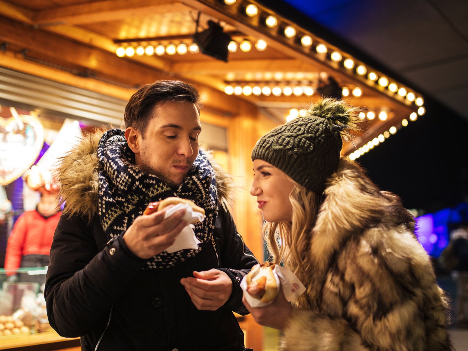 Couple eating brats and smiling during holidays