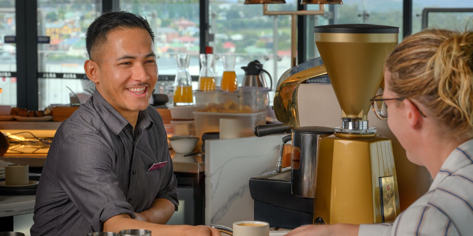 man serving woman a coffee