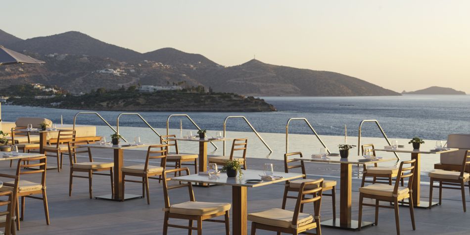 outdoor dining with an infinity pool view flowing into stunning ocean views 