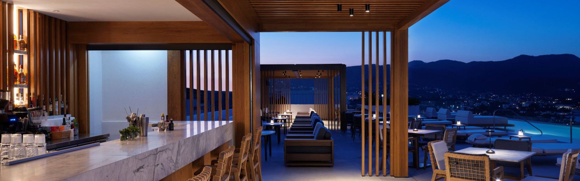 minoan at night, view of the bar, infinity pool and mirabello bay
