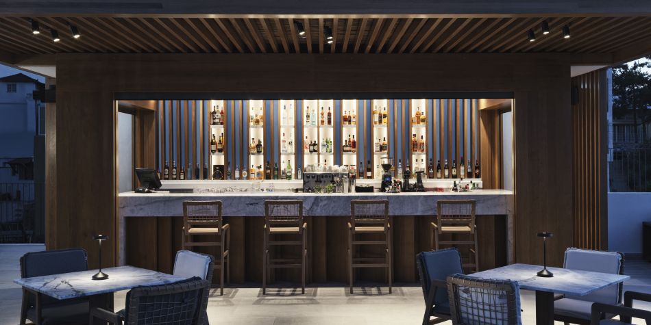 front view of Minoan bar, showing bar stools, and plenty drink and spirit options