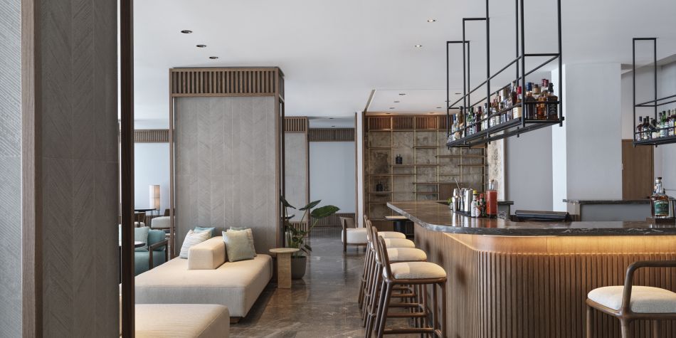 bar area at zeus with bar stools, wooden panelling and plenty drink options on view