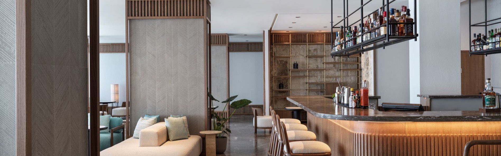 zeus bar area with bar stools and plenty drink options