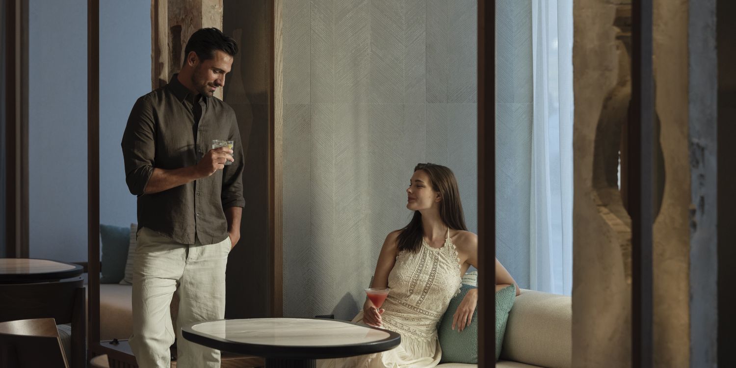 couple lounging in zeus with drinks