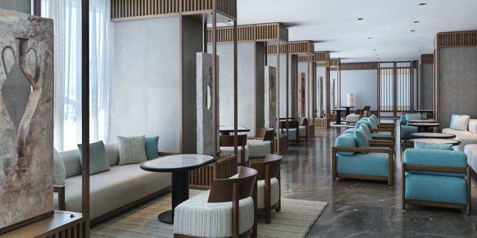 large lounge seating area with neautral booths and cosy armchairs
