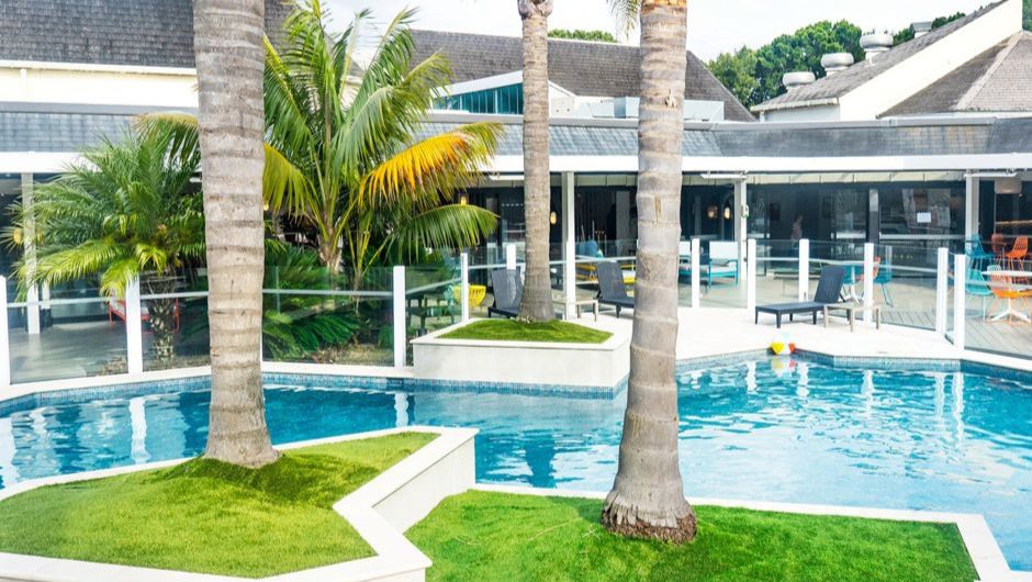Holiday Inn Auckland Airport lobby decorated with traditional Maori carvings
