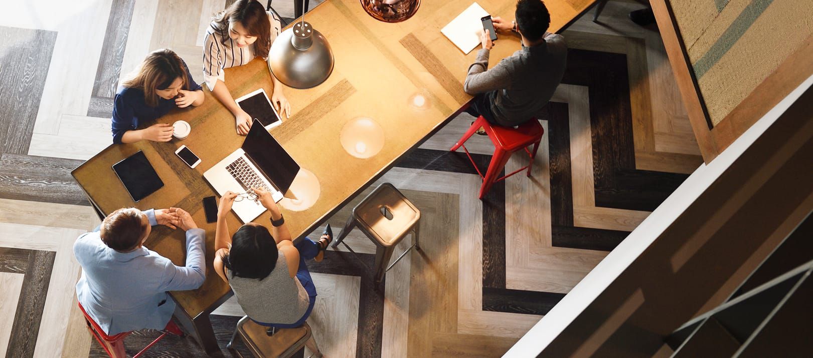 Overhead view of people working at a conference table