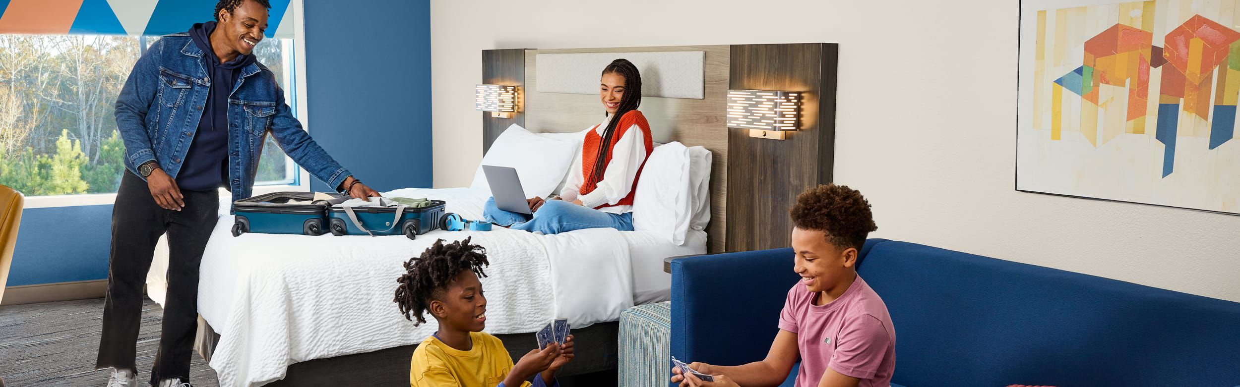 Family unpacking in their hotel room
