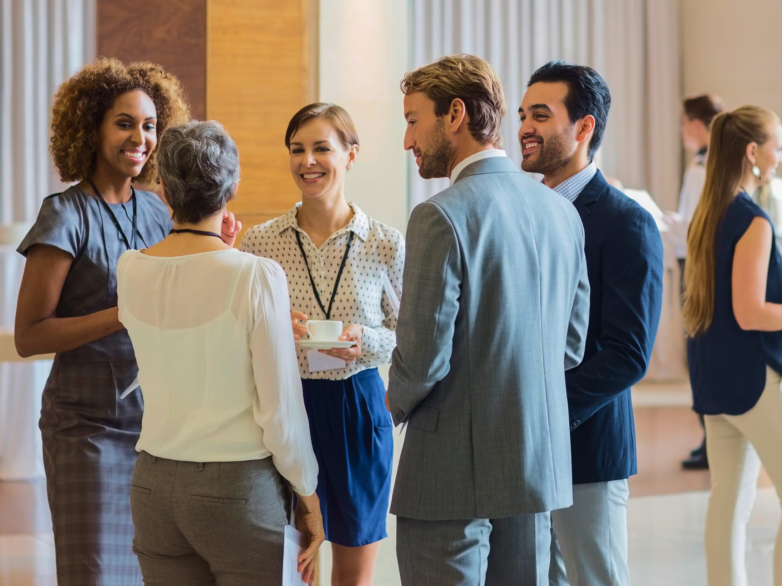 Business people gathered in conversation
