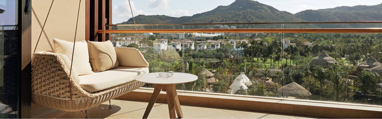 Balcony with comfy swing seat overlooking the lush mountainside
