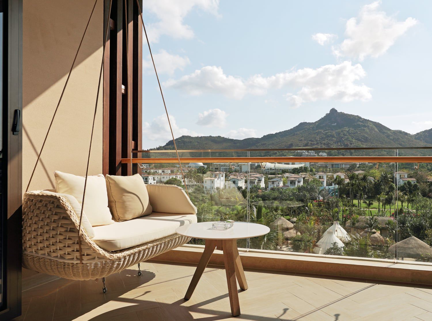 Balcony with comfy swing seat overlooking the lush mountainside