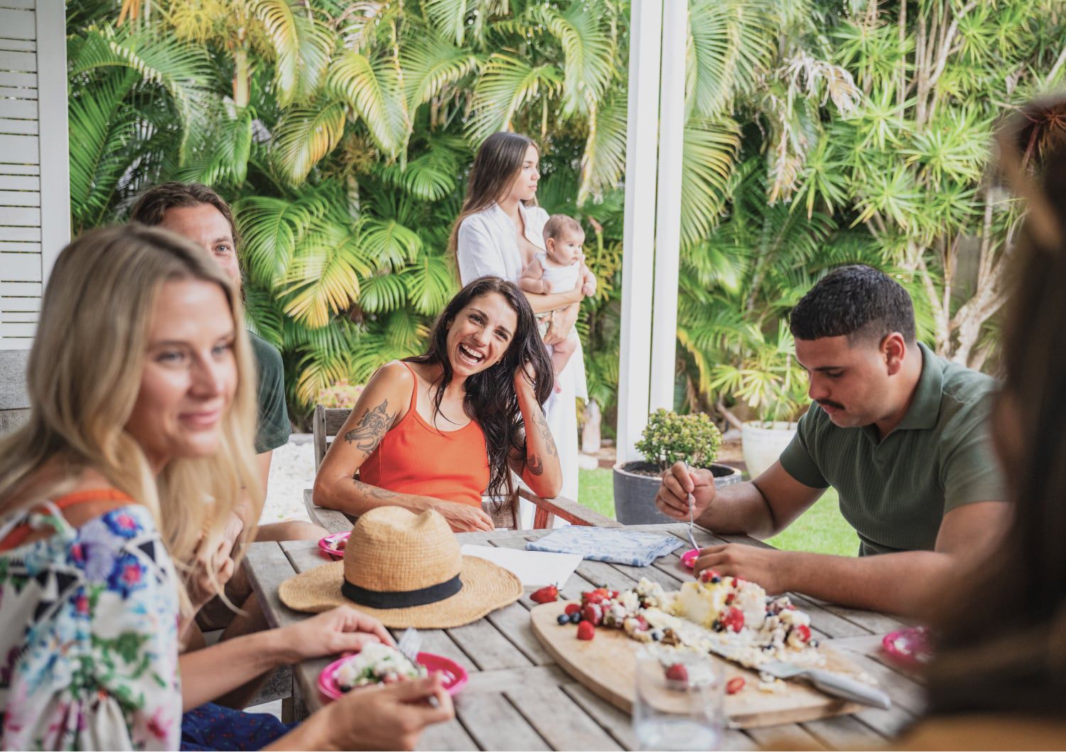 Friends enjoying a meal outdoors on a patio